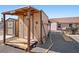 Exterior view of a rustic storage shed with assorted tools, and a small wagon wheel in the background at 3581 Ranger Way, Pahrump, NV 89048