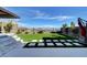 Beautiful backyard featuring artificial turf, stone pavers, and lush landscaping, perfect for outdoor enjoyment at 394 Red Feather Peak Ct, Las Vegas, NV 89138