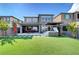 Lovely backyard featuring a hot tub, outdoor seating, and artificial grass, perfect for gatherings at 394 Red Feather Peak Ct, Las Vegas, NV 89138