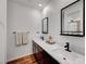 Modern bathroom featuring double sinks, dark fixtures, and contrasting mirrors over a light countertop at 394 Red Feather Peak Ct, Las Vegas, NV 89138