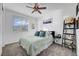 Cozy bedroom with a queen-size bed, plush carpet, ceiling fan, and ample natural light at 394 Red Feather Peak Ct, Las Vegas, NV 89138
