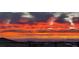 Panoramic city view featuring vibrant sunset colors over the skyline and distant mountains at 394 Red Feather Peak Ct, Las Vegas, NV 89138