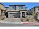 Charming two-story home with a paved driveway, attached garage, and inviting front entrance at 394 Red Feather Peak Ct, Las Vegas, NV 89138