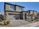 Two-story home featuring a paved driveway, attached garage, and well-maintained landscaping at 394 Red Feather Peak Ct, Las Vegas, NV 89138