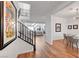 Inviting foyer showcasing hardwood floors, staircase, and artwork leading into the adjacent dining and living room areas at 394 Red Feather Peak Ct, Las Vegas, NV 89138