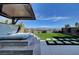 Relax in this backyard hot tub with pergola, stylish pavers, and artificial turf at 394 Red Feather Peak Ct, Las Vegas, NV 89138