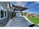 Enjoy the backyard hot tub and pergola, complemented by lush artificial turf and modern landscaping at 394 Red Feather Peak Ct, Las Vegas, NV 89138