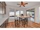 Bright kitchen nook with modern table, wood floors, and sliding glass doors to outdoor living area at 394 Red Feather Peak Ct, Las Vegas, NV 89138