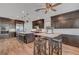 Modern kitchen with dark wood cabinets, stainless steel appliances, and large center island at 394 Red Feather Peak Ct, Las Vegas, NV 89138