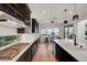 Modern kitchen with stainless appliances, dark cabinets, and ample counter space at 394 Red Feather Peak Ct, Las Vegas, NV 89138