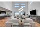 Bright and open living area features a fireplace, hardwood floors, and abundant natural light from the large windows at 394 Red Feather Peak Ct, Las Vegas, NV 89138