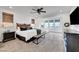 Spacious main bedroom with a large window, seating area, and modern furnishings at 394 Red Feather Peak Ct, Las Vegas, NV 89138