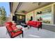 Inviting outdoor living space with comfortable seating, a ceiling fan, and views of the manicured backyard at 394 Red Feather Peak Ct, Las Vegas, NV 89138