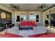 Inviting outdoor living space with comfortable seating, a ceiling fan, and views of the manicured backyard at 394 Red Feather Peak Ct, Las Vegas, NV 89138
