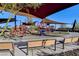Shaded community playground featuring slides, climbing structures, and play equipment for enjoyment at 394 Red Feather Peak Ct, Las Vegas, NV 89138