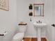Stylish powder room with pedestal sink, decorative mirror and modern fixtures at 394 Red Feather Peak Ct, Las Vegas, NV 89138