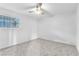 Comfortable bedroom with neutral carpet, fan and a window providing natural light at 3946 Torsby Pl # 3946, Las Vegas, NV 89119