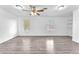Large bonus room boasting wood-look flooring, a fan, and two windows at 3946 Torsby Pl # 3946, Las Vegas, NV 89119
