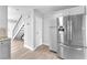 Well-equipped kitchen features stainless steel refrigerator and convenient access to the staircase at 3946 Torsby Pl # 3946, Las Vegas, NV 89119