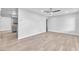 Bright living room featuring wood-look flooring, a modern ceiling fan, and neutral paint at 3946 Torsby Pl # 3946, Las Vegas, NV 89119