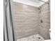 Close-up of a tiled shower with a mosaic tile floor and modern fixtures at 3946 Torsby Pl # 3946, Las Vegas, NV 89119