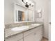 Close up on the dual sink bathroom vanity with granite countertops and modern fixtures at 3986 Visby Ln, Las Vegas, NV 89119