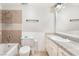 Bathroom featuring a single sink vanity with a granite top and tile accents around the bathtub at 3986 Visby Ln, Las Vegas, NV 89119