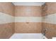 Close-up of the tiled shower and tub, complete with a shower caddy at 3986 Visby Ln, Las Vegas, NV 89119