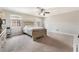 The light filled spacious bedroom features neutral carpet, ceiling fan, and large windows at 3986 Visby Ln, Las Vegas, NV 89119