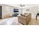 Cozy living room with tile flooring, comfortable seating, and a large window at 3986 Visby Ln, Las Vegas, NV 89119