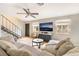 Bright and inviting living room with tile floors, a large sectional sofa, and modern amenities at 3986 Visby Ln, Las Vegas, NV 89119