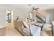 Comfortable living room featuring tile floors, a spacious sectional, and a convenient laundry area at 3986 Visby Ln, Las Vegas, NV 89119