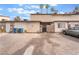 Exterior street view of a residential building with gravel, limited parking and gated entry at 3986 Visby Ln, Las Vegas, NV 89119