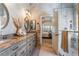 Luxurious bathroom featuring dual sinks, granite counters, and a beautifully tiled shower with glass door at 4014 Trapani Pl, Las Vegas, NV 89141