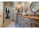 Elegant bathroom featuring double sinks with granite counters, neutral walls and tile flooring and walk-in closet at 4014 Trapani Pl, Las Vegas, NV 89141