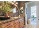 Charming bathroom featuring an ornate mirror, granite countertop, custom vanity and neutral decor at 4014 Trapani Pl, Las Vegas, NV 89141