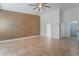 Bedroom featuring tile flooring, a ceiling fan, walk-in closet, an accent wall and neutral paint at 4014 Trapani Pl, Las Vegas, NV 89141