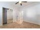 Bright bedroom featuring tile flooring, a ceiling fan, closet with mirror doors and neutral paint at 4014 Trapani Pl, Las Vegas, NV 89141