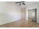 Bright bedroom featuring tile flooring, a ceiling fan, closet with mirror doors and neutral paint at 4014 Trapani Pl, Las Vegas, NV 89141