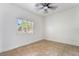 Bedroom featuring tile flooring, a ceiling fan, and a window with shutters at 4014 Trapani Pl, Las Vegas, NV 89141