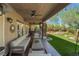 A view of the large covered patio with outdoor seating, ceiling fans, and access to a luxurious outdoor kitchen at 4014 Trapani Pl, Las Vegas, NV 89141