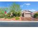 Charming single-story home featuring a well-manicured front yard, desert landscaping, and a two-car garage at 4014 Trapani Pl, Las Vegas, NV 89141