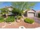 Inviting home exterior with desert landscaping, mature trees, and a well-maintained lawn leading to the garage at 4014 Trapani Pl, Las Vegas, NV 89141