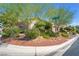 Attractive home exterior featuring manicured desert landscaping with trees, shrubs, and decorative rock accents at 4014 Trapani Pl, Las Vegas, NV 89141