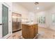 Spacious eat-in kitchen featuring a center island, stainless steel refrigerator, and abundant natural light at 4014 Trapani Pl, Las Vegas, NV 89141