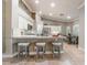 Bright, open kitchen featuring white cabinets, stainless steel appliances, counter seating, and an adjacent dining area at 4014 Trapani Pl, Las Vegas, NV 89141
