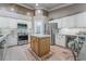 A well-lit kitchen with stainless steel appliances, a center island, and custom cabinetry, perfect for cooking at 4014 Trapani Pl, Las Vegas, NV 89141