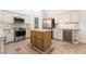 Well-equipped kitchen with stainless steel appliances, custom cabinetry, a center island and tile flooring at 4014 Trapani Pl, Las Vegas, NV 89141
