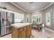 Bright, open kitchen with stainless steel appliances, center island, breakfast nook, and abundant natural light at 4014 Trapani Pl, Las Vegas, NV 89141