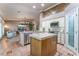 Open-concept kitchen featuring a central island, stainless steel appliances, and seamless flow to the living area at 4014 Trapani Pl, Las Vegas, NV 89141